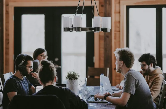 work meeting, office, collaboration, laptop, headphones, modern, discussion, man, woman, youth, creativity, technology, café, teamwork, modern office, group work, interior, light, people. How to define a startup funding target audience in England